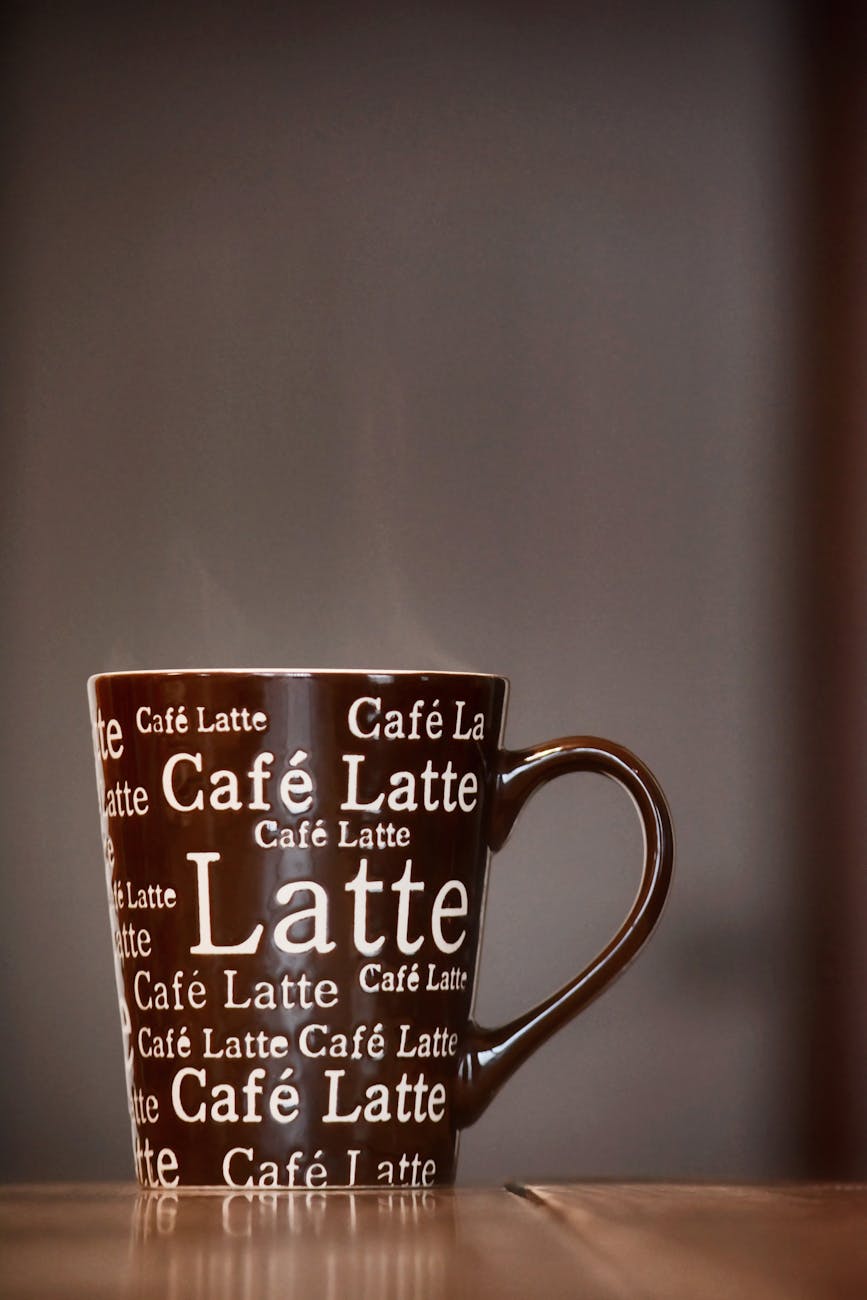 brown and white ceramic mug
