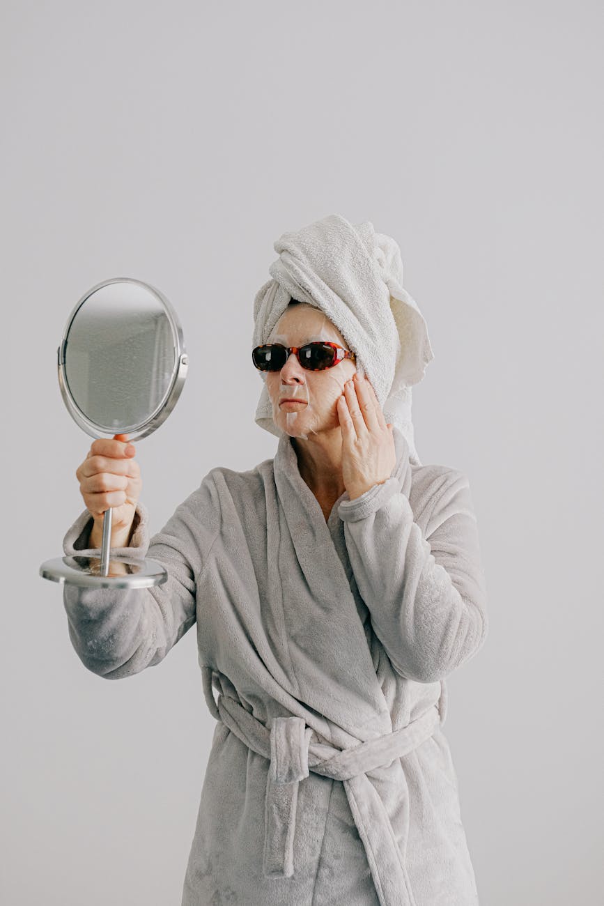 woman in gray bathrobe wearing black sunglasses