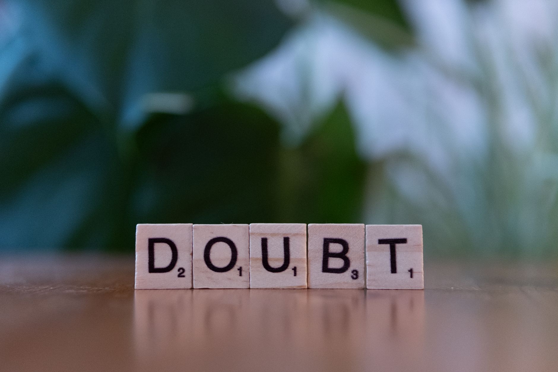wooden scrabble tiles spelling doubt